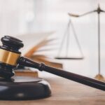 Judge’s gavel and legal scales beside open law book symbolizing wills and living trusts in California.